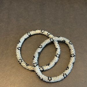 Twin beaded bracelets, one size, silver beads with black flower design.